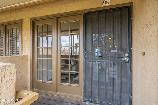 property entrance with stucco siding