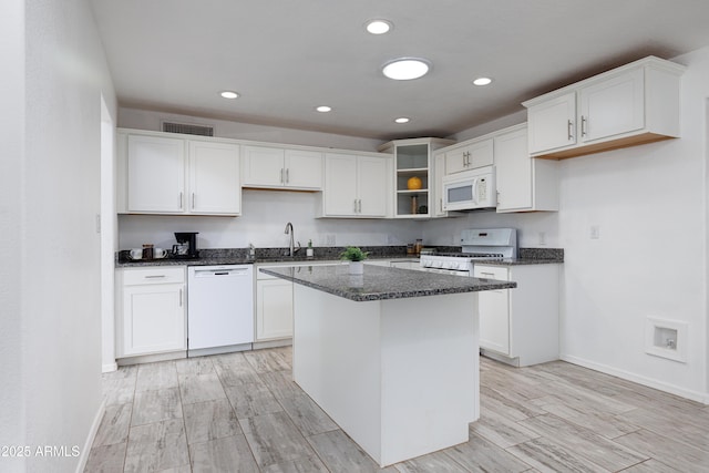 kitchen featuring recessed lighting, baseboards, white appliances, a sink, and open shelves