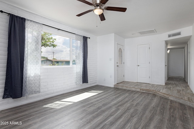 unfurnished bedroom featuring visible vents, wood finished floors, baseboards, and ceiling fan