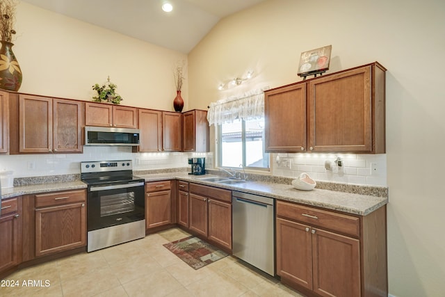 kitchen featuring decorative backsplash, light tile patterned flooring, sink, and stainless steel appliances