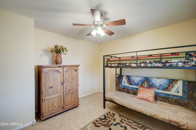 tiled bedroom featuring ceiling fan