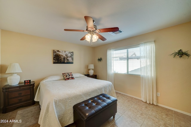 tiled bedroom with ceiling fan