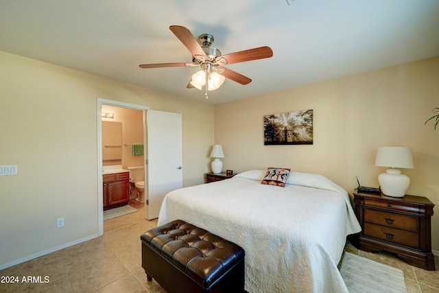 bedroom featuring ceiling fan, light tile patterned flooring, and ensuite bathroom