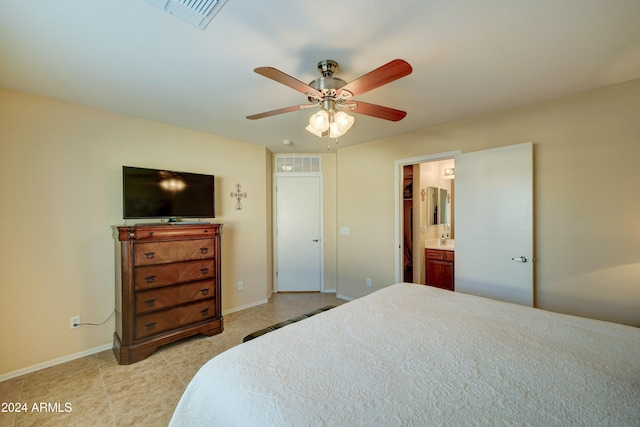 bedroom with ensuite bath, ceiling fan, and light tile patterned floors