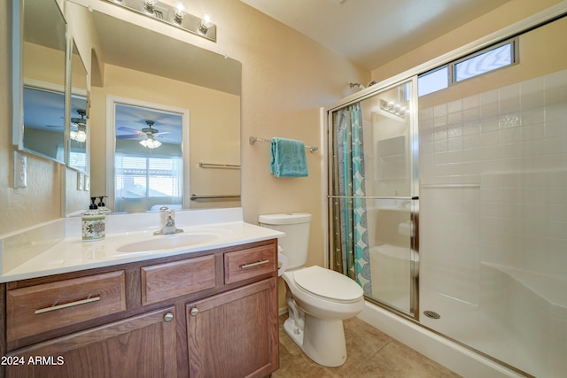 bathroom featuring vanity, tile patterned flooring, ceiling fan, toilet, and walk in shower