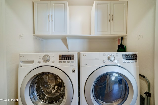 laundry area featuring cabinets and separate washer and dryer