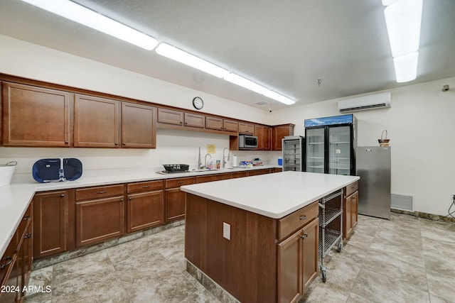 kitchen with a center island, sink, and a wall mounted AC