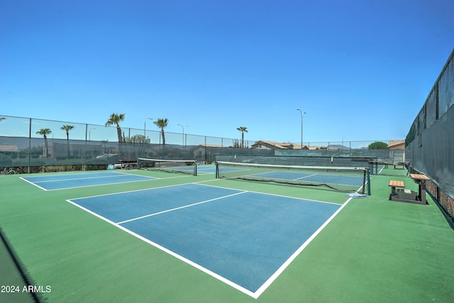 view of tennis court with basketball hoop