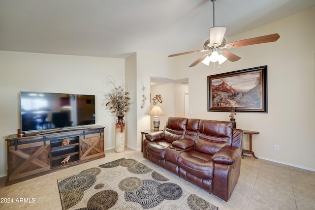 living room with ceiling fan, light tile patterned floors, and vaulted ceiling