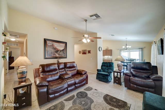 tiled living room with ceiling fan with notable chandelier and lofted ceiling