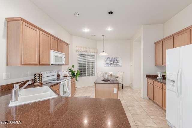 kitchen featuring light tile patterned floors, a sink, white appliances, and a kitchen island