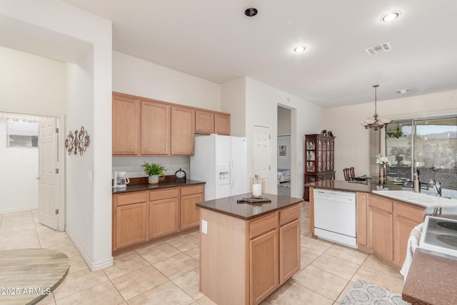 kitchen featuring light tile patterned floors, visible vents, a sink, dark countertops, and white appliances