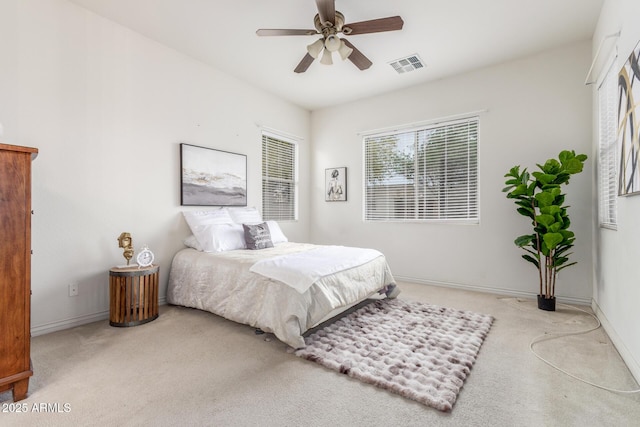 bedroom with visible vents, baseboards, carpet flooring, and ceiling fan