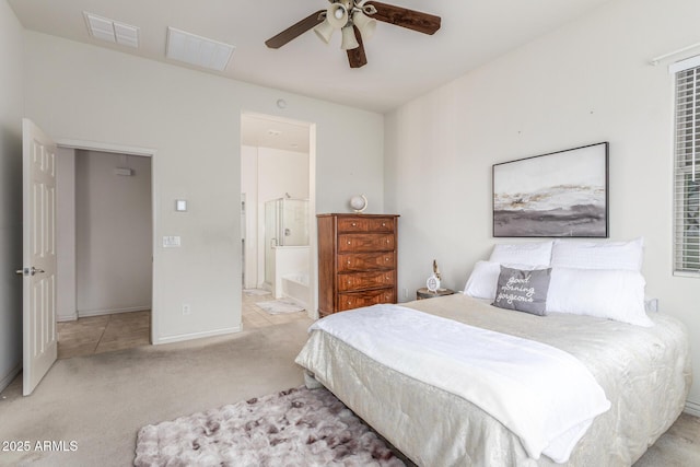 bedroom with baseboards, carpet flooring, a ceiling fan, connected bathroom, and visible vents