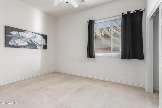 unfurnished room featuring carpet flooring, baseboards, and ceiling fan