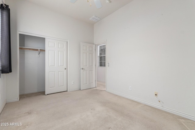 unfurnished bedroom featuring a closet, baseboards, carpet floors, visible vents, and ceiling fan