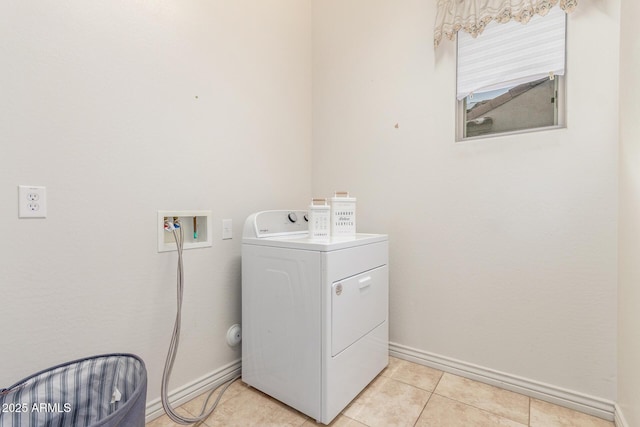 clothes washing area featuring washer / clothes dryer, baseboards, laundry area, and light tile patterned floors