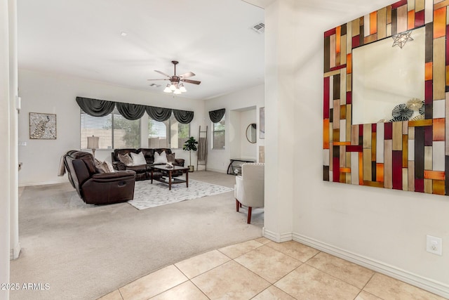 living area with light carpet, baseboards, a ceiling fan, and visible vents