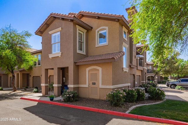 view of front of house with stucco siding and a tiled roof