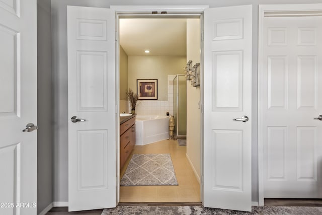 full bathroom with vanity, baseboards, tile patterned flooring, an enclosed shower, and a bathtub
