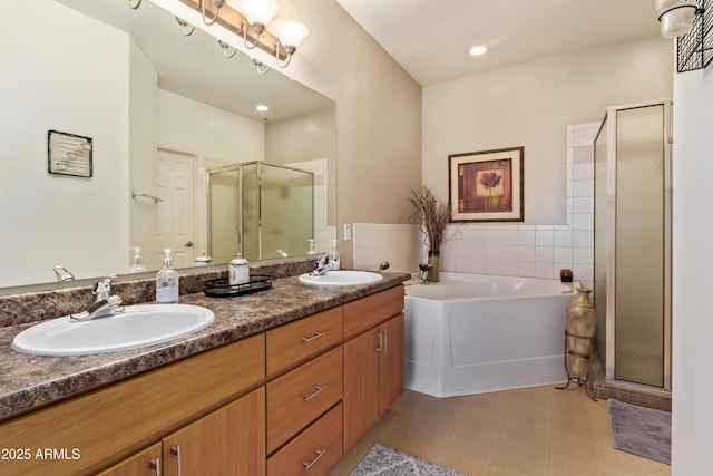 bathroom with a sink, a shower stall, double vanity, and a garden tub