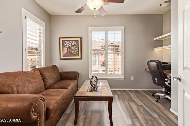 office area with wood finished floors, baseboards, and a ceiling fan