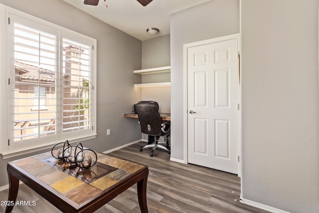 home office featuring wood finished floors, baseboards, and a ceiling fan