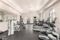 exercise room featuring a tray ceiling and ornamental molding