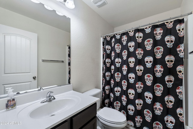 bathroom featuring vanity, a shower with shower curtain, and toilet