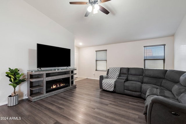 living room with dark hardwood / wood-style floors, vaulted ceiling, and ceiling fan