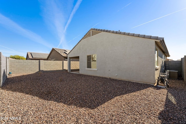 rear view of property featuring central AC unit