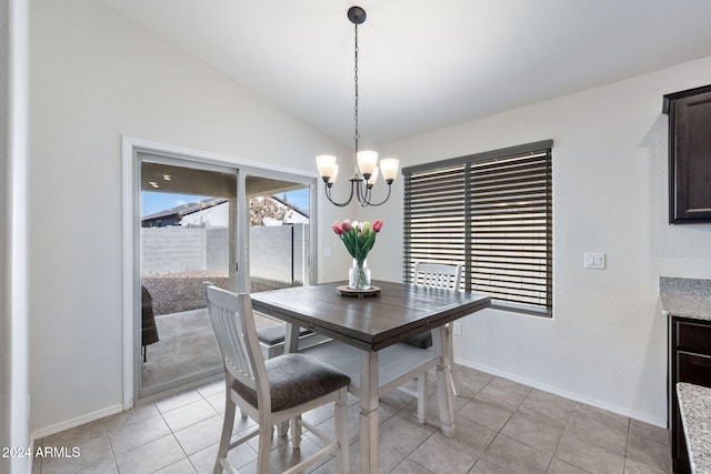 dining area with light tile patterned floors, lofted ceiling, and an inviting chandelier