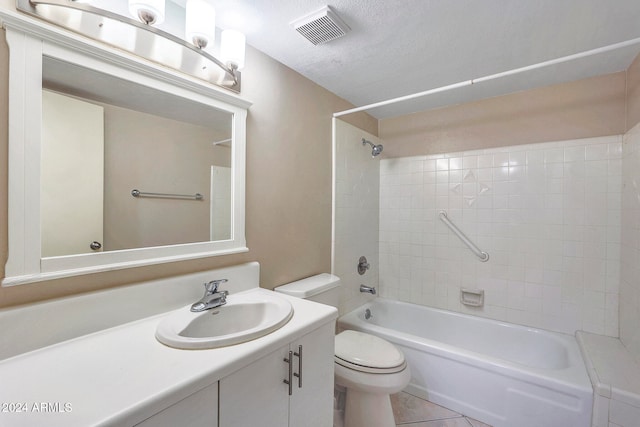 full bathroom featuring tile patterned floors, vanity, a textured ceiling, tiled shower / bath combo, and toilet