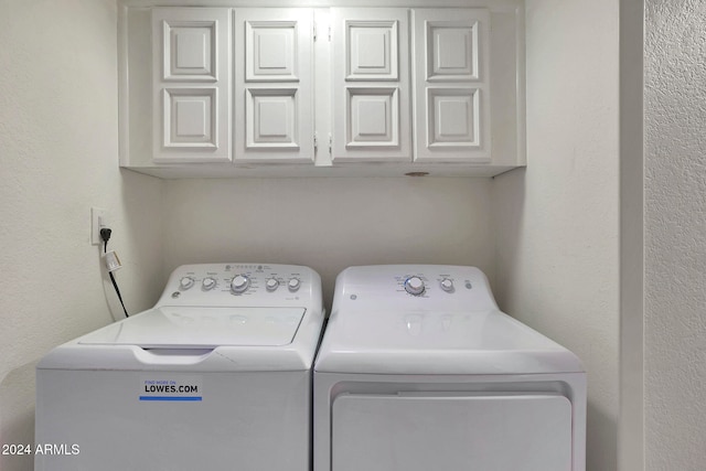 washroom with cabinets and separate washer and dryer