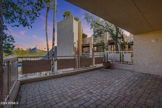 patio terrace at dusk with a balcony