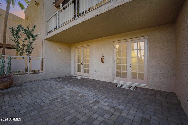 patio terrace at dusk featuring french doors