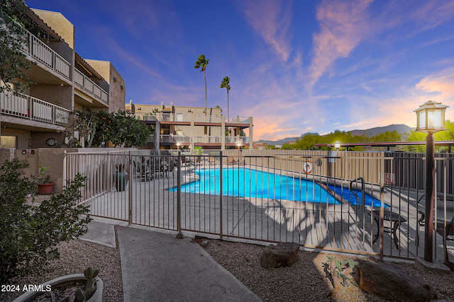 pool at dusk with a patio