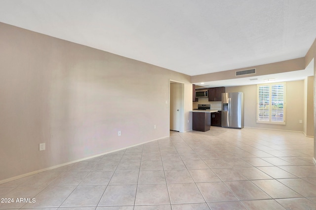 unfurnished living room featuring light tile patterned floors