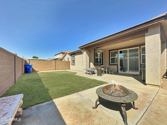 view of yard with an outdoor fire pit, a fenced backyard, and a patio area