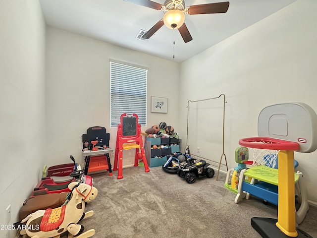 recreation room with visible vents, carpet, and a ceiling fan