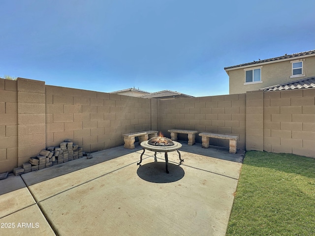 view of patio / terrace featuring a fire pit and fence