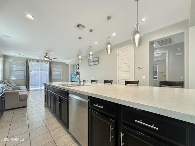 kitchen featuring visible vents, dark cabinets, a sink, dishwasher, and open floor plan