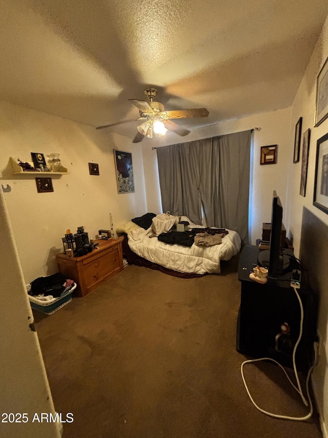 bedroom featuring carpet, a textured ceiling, and ceiling fan