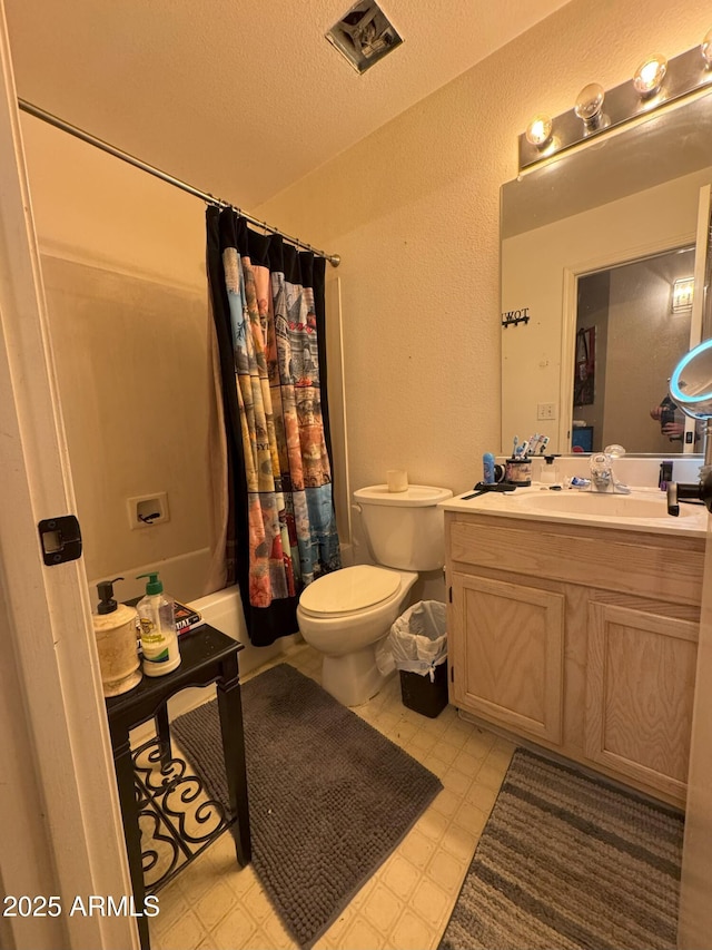 full bathroom featuring shower / tub combo, vanity, a textured ceiling, and toilet