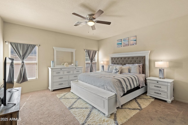 bedroom featuring light carpet, baseboards, and a ceiling fan