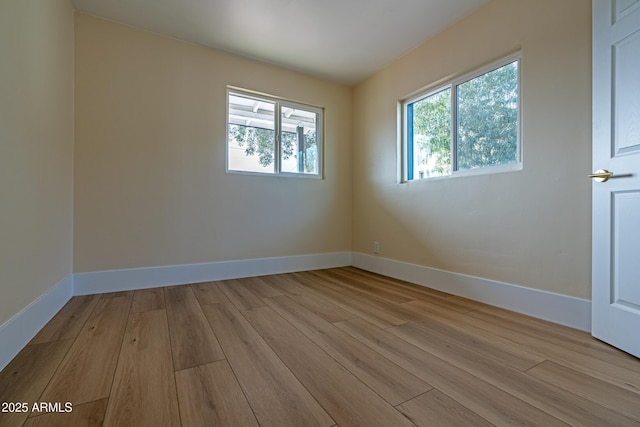 empty room with a healthy amount of sunlight and light wood-type flooring