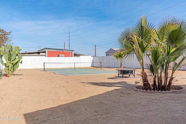 view of property's community with tennis court and basketball hoop