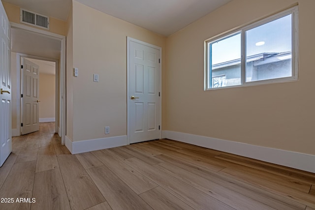 spare room featuring light wood-type flooring