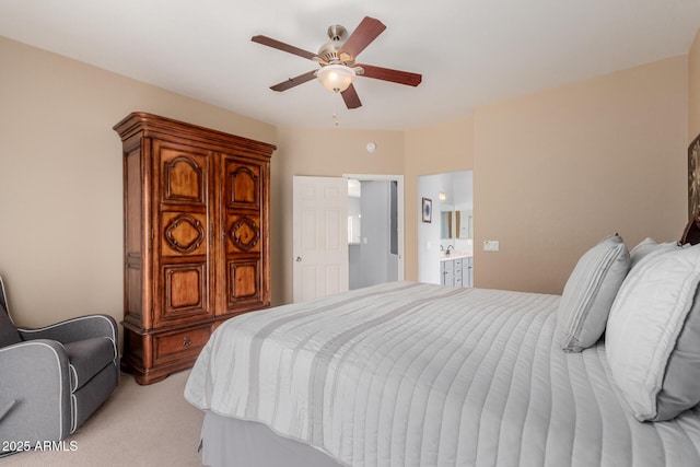 bedroom with light colored carpet, connected bathroom, and ceiling fan