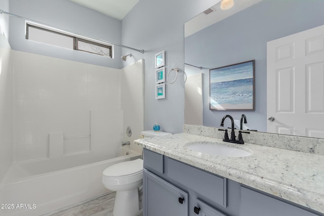 bathroom with vanity, wood finished floors, toilet, and washtub / shower combination